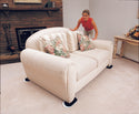 Woman moving loveseat with EZ Moves II Furniture Slides for Carpet (Set of 4)