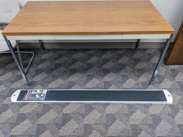 Packaged set of Professional Pull Slides For Soft Surfaces - 6' (Set of 2) on carpeted floor next to a table.