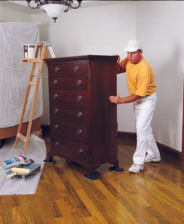 Painter moving tall dresser across wood floor with Professional Furniture Slides for Hardwood and Tile (Set of 4)