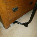 PowerMaxx Furniture Lifter under light brown dresser