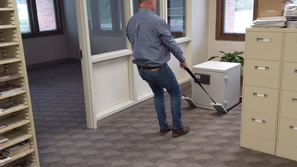 Man using Pull Straps (Set of 2) and Pull Slide to move an office safe.
